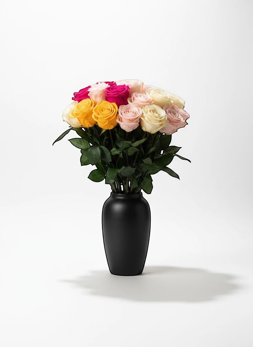 floragram mixed bouquet of long-stem preserved roses in pink, yellow, and cream shades in a black vase
