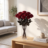 Dark red long stem preserved roses arranged in a glass vase